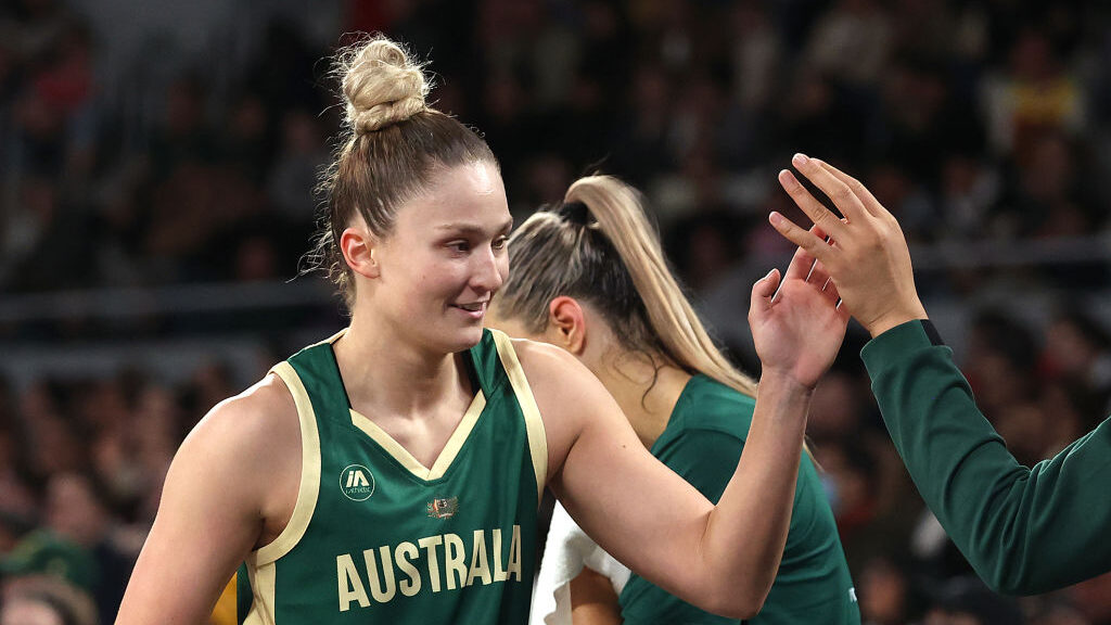 Amy Atwell, guard for the Australian Opals, high-fives teammates during a pre-Olympic game against ...