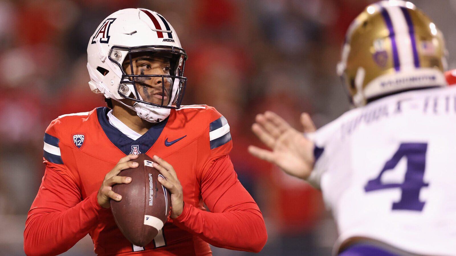 Arizona quarterback Noah Fifita dropping back to pass...