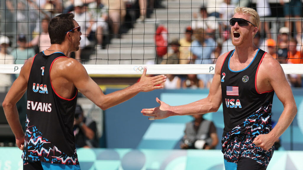 Beach volleyball Olympians Miles Evans and Chase Budinger of Team United States high five...