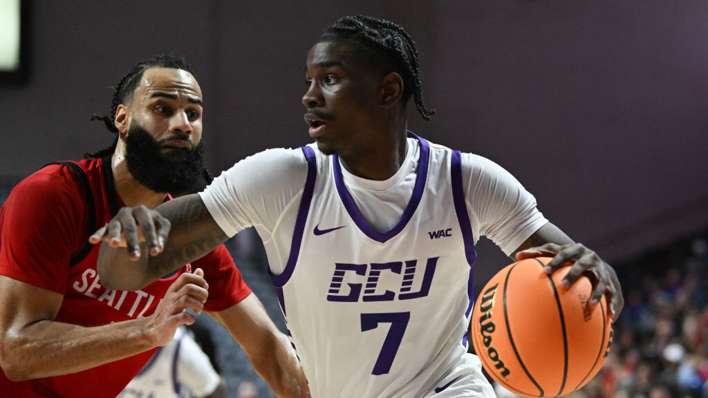 Tyon Grant-Foster drives the basketball...