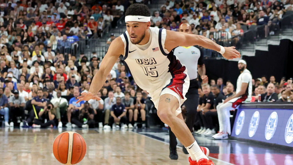 Devin Booker #15 of the United States drives against Canada in the second half of their exhibition ...