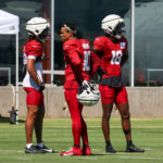 Trio of Arizona Cardinals wide receivers look on during practice on Thursday, Sept. 19, 2024, in Tempe. (Tyler Drake/Arizona Sports)