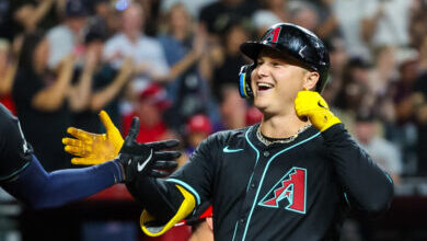 Joc Pederson #3 of the Arizona Diamondbacks celebrates his solo home run with Josh Bell #36 during ...