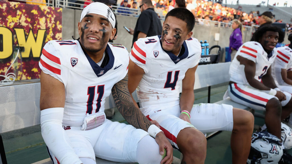 Quarterback Noah Fifita #11 and wide receiver Tetairoa McMillan #4 of the Arizona Wildcats...