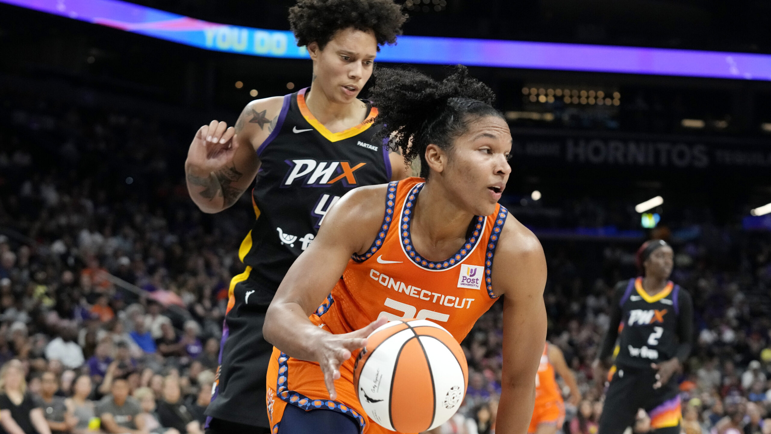 Connecticut Sun forward Alyssa Thomas, right, dribbles past Phoenix Mercury center Brittney Griner,...
