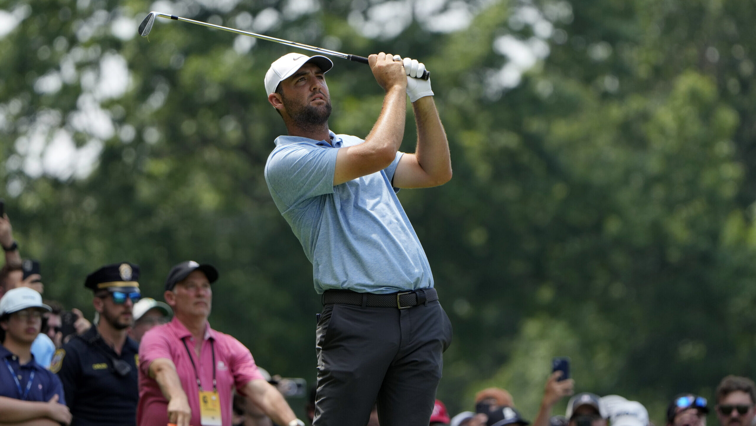 Scottie Scheffler tees off on the 11th hole during the final round of the Travelers Championship go...